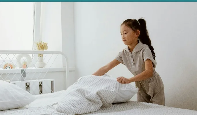 Child focused and engaged at a desk in a bright room