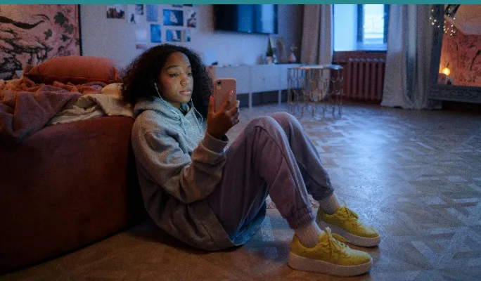 Teenager sitting alone, looking disengaged