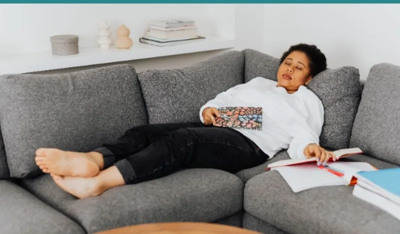 Exhausted parent at kitchen table with coffee in the morning
